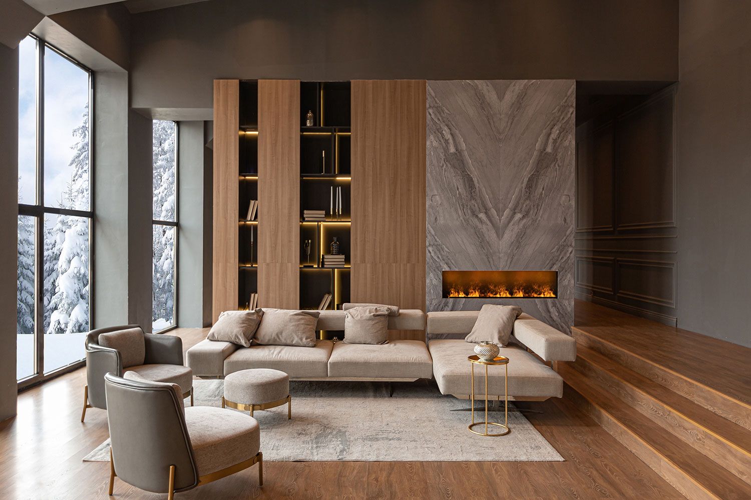 Cozy living room decorated in white, gray and brown with a large corner sofa and armchairs in the middle on a carpet, a marbled fireplace can be seen in the background, the room is illuminated by a modern glass front on the left side of the picture